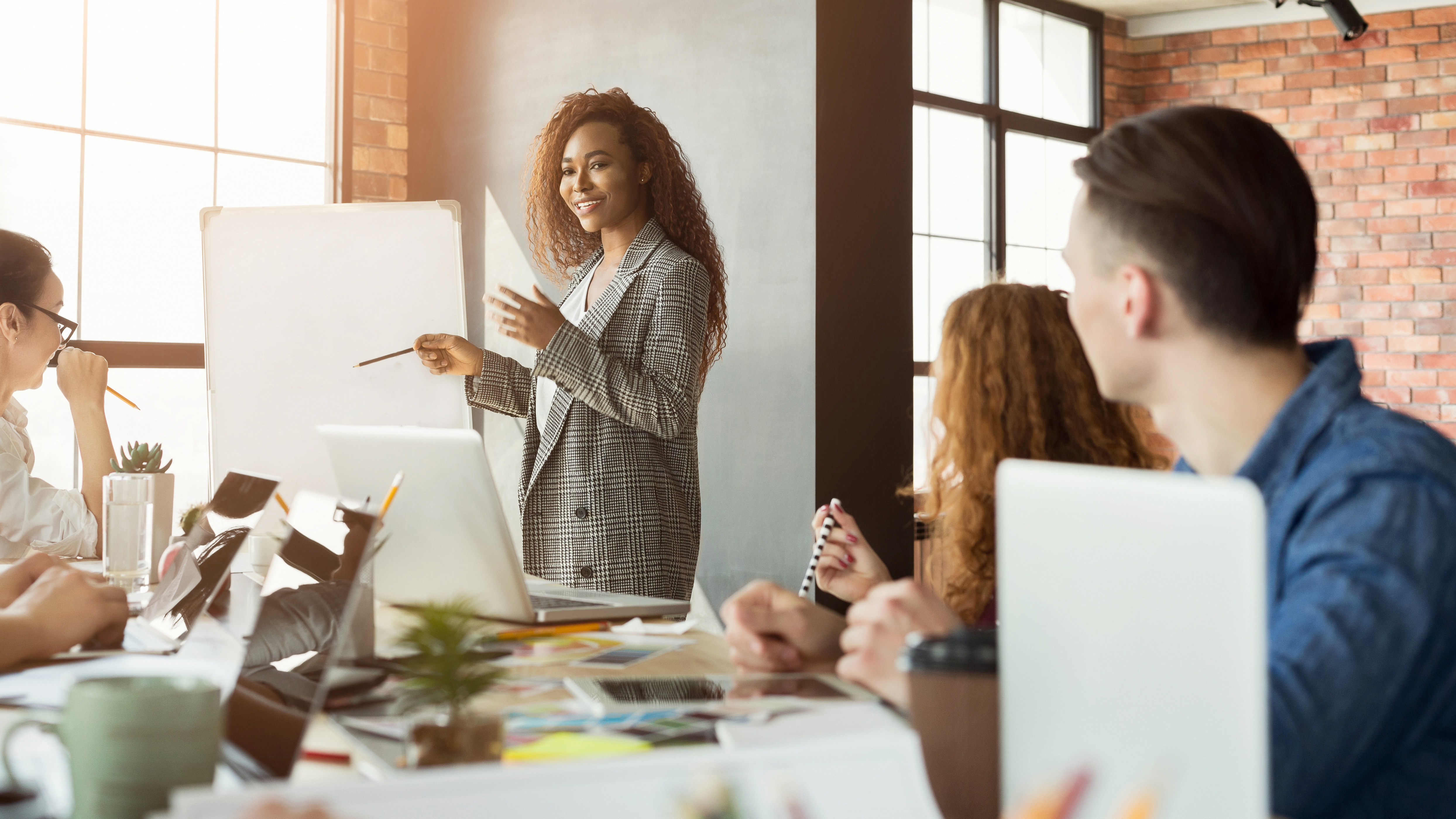 Businesswoman giving presentation to team of people