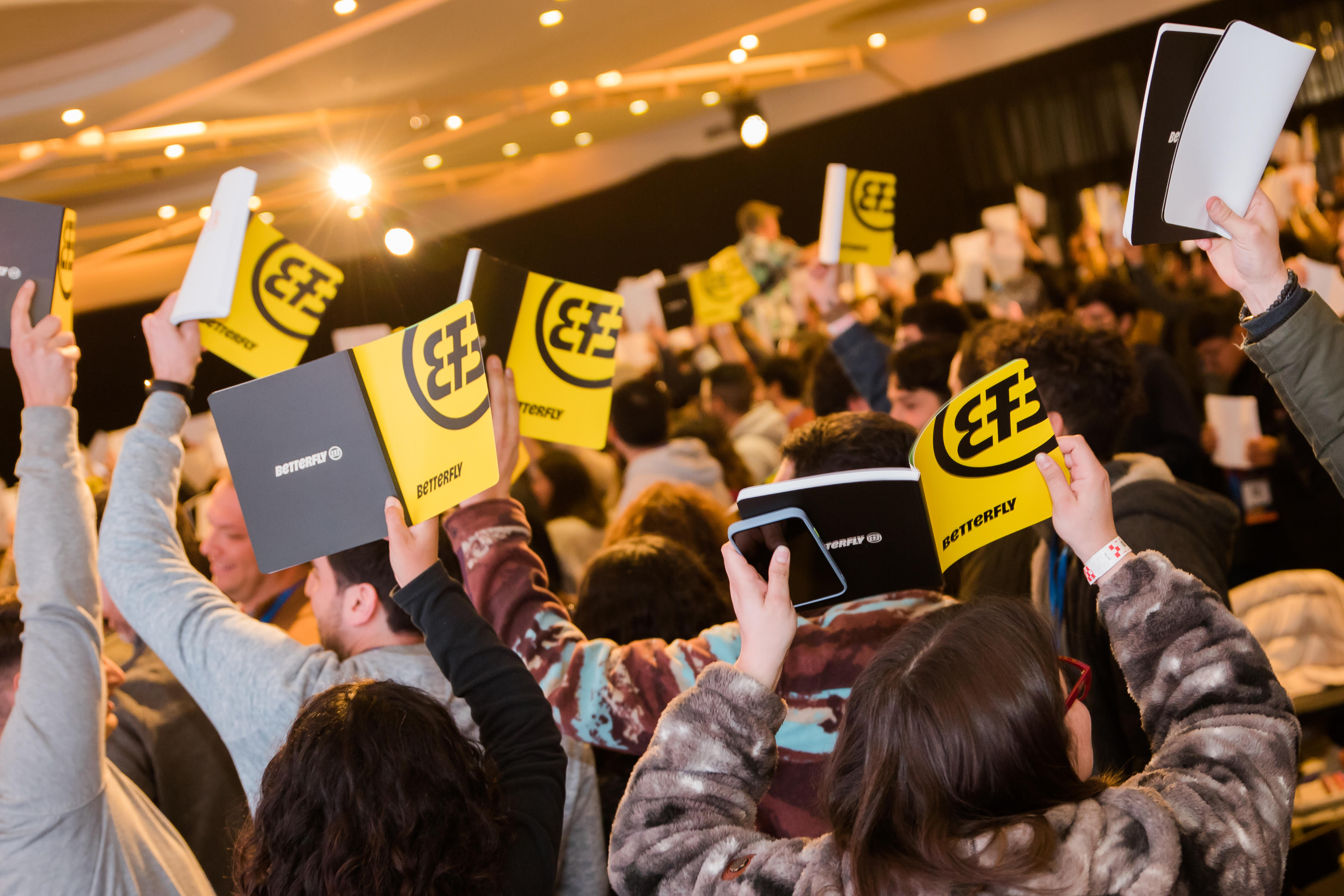 Betterfly team holding signs