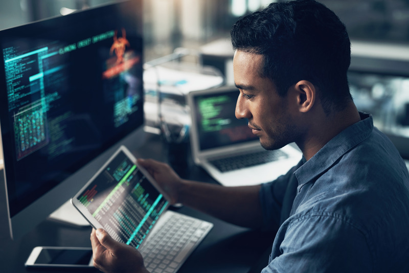 photo of man looking at computer